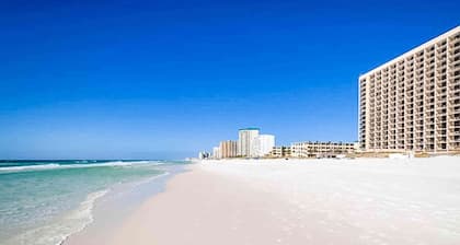 Colorful 6th-floor condo with partial gulf view, balcony, pool, hot tub, W/D, AC