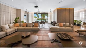 A modern hotel lobby with a large seating area, a dining table, and a view of palm trees. - 44th-Floor Luxury Condo - Gym & Pool (Miami)