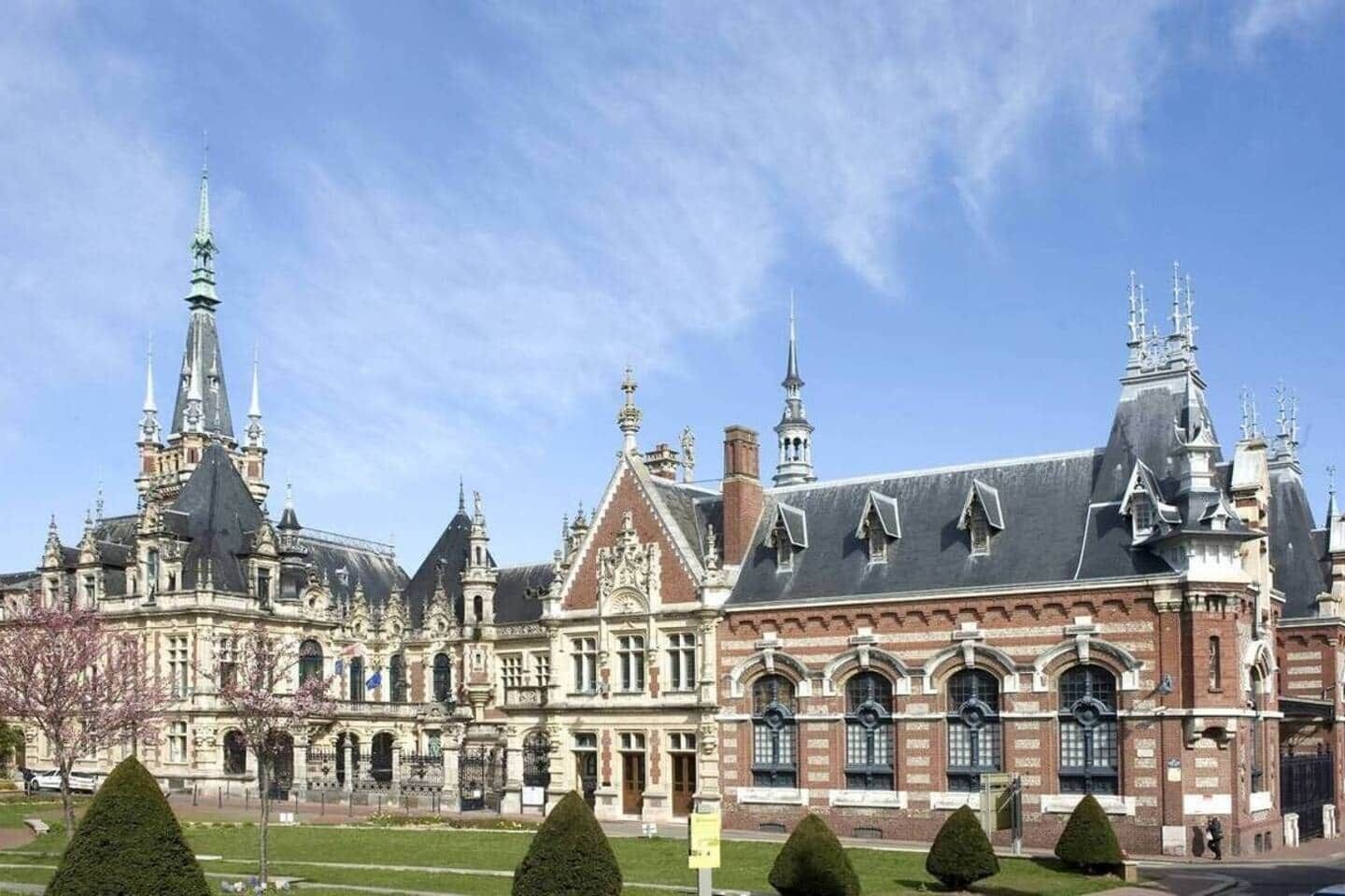 A historic building with ornate architecture, including multiple spires and a large central entrance.