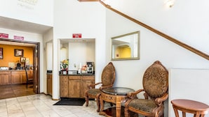 A hotel lobby with a staircase, a reception desk, a coffee station, and two ornate chairs. - Econo Lodge Inn and Suites Albuquerque East I-40 Eubank Exit (Albuquerque)