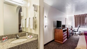 A hotel room with a bathroom, a desk, a TV, and a bed. - Econo Lodge Inn and Suites Albuquerque East I-40 Eubank Exit (Albuquerque)