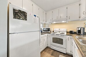 Your fully equipped kitchen makes preparing meals a breeze, with modern appliances, ample counter space, and all the essentials you'll need for cooking at home. - Welcome to Sound of the Sea 102N (Emerald Isle)