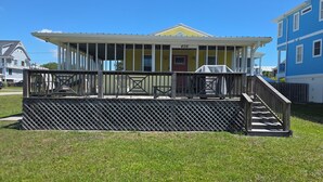 A two-story building with a covered porch and a number '406' sign.