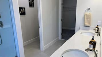 Een douche, handdoeken, zeep, toiletpapier