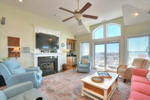 TV, books - Experience ocean views in this spacious 4-bed, 3-bath home on Oak Island. (Oak Island)