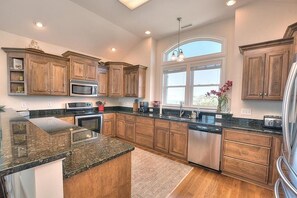 Fridge, microwave, oven, stovetop - Experience ocean views in this spacious 4-bed, 3-bath home on Oak Island. (Oak Island)
