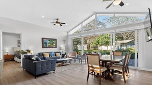 A spacious living room with a large dining table, sofas, and a ceiling fan. - Casa 17 at The Point // Playa Avellanas // 25 min to Tamarindo (Playa Avellanas)
