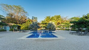 A rectangular swimming pool with a clear blue center, surrounded by a gravel area with lounge chairs. - Casa 17 at The Point // Playa Avellanas // 25 min to Tamarindo (Playa Avellanas)
