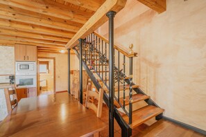 A wooden staircase with black railings leading to an upper floor. - Rural House 'Gemelas Del Duratón' with Mountain Views, Private Garden and Wi-Fi (Castro de Fuentidueña)