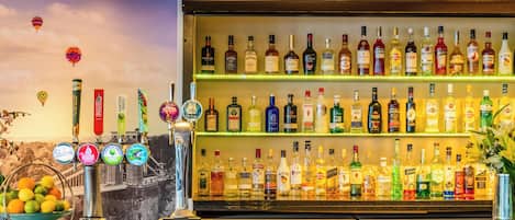 A bar with multiple liquor bottles and a beer tap.