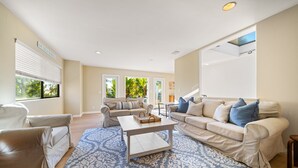 A living room with two sofas, a coffee table, and a patterned rug. - Sunsets at the Shore House (San Diego)