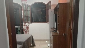 A room with a bed, a TV, and a cabinet.