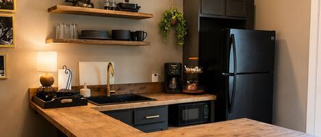 Fridge, microwave, coffee/tea maker, cookware/dishes/utensils