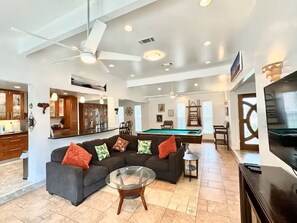 A spacious living area with a pool table, a sofa set, and a television. - Family Fun! Hot tub, Pool, Billiards, Gazeb (Richland Hills)