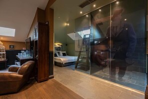 A bedroom with a bed, a chair, a desk, and a large window. - Civiltà Boutique (Antwerp)