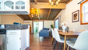 A modern kitchen with white cabinets, a granite countertop, and a built-in dishwasher. - Central 3BR 2BA Near Santana Row & Valley Fair (San Jose)