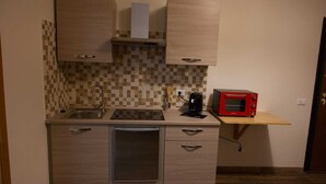 A compact kitchen with a dishwasher, a microwave, and a small countertop. - Vacation Home Sweet Angel 17, with view of Amphitheater (Sutri)
