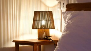 A bed with a white pillow, a bedside table with a lamp, and a window with blinds. - Vacation Home Sweet Angel 17, with view of Amphitheater (Sutri)