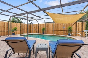 A covered outdoor swimming pool with lounge chairs and a shaded area. - 2BR2BATH Venice Poolside Retreat (Venice)