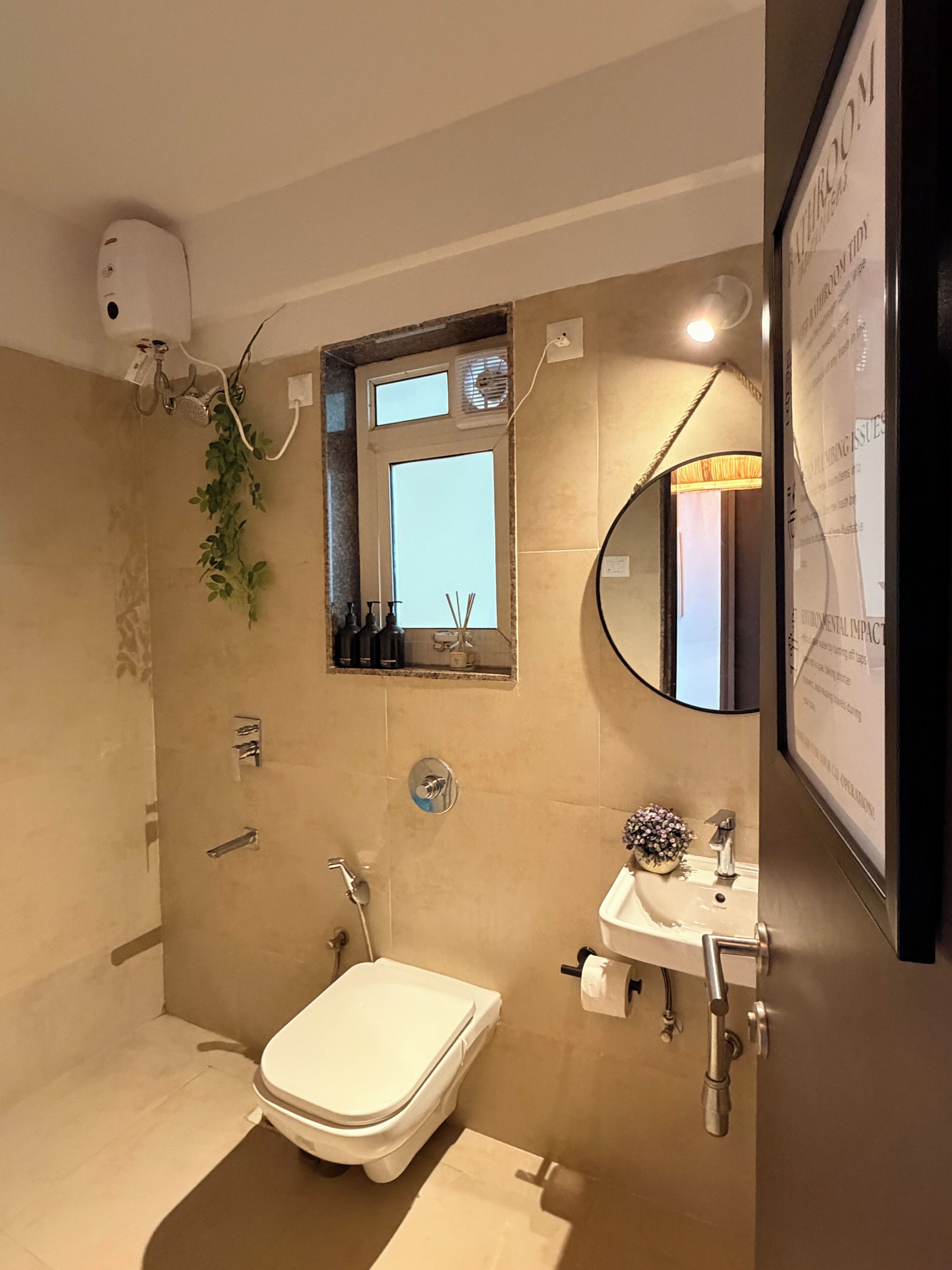 A modern bathroom with a toilet, sink, and shower area.