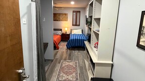 A bedroom with a bed, bedside table, lamp, and a wardrobe. - Germantown Inn & Lounge RM 5 (Hermann)