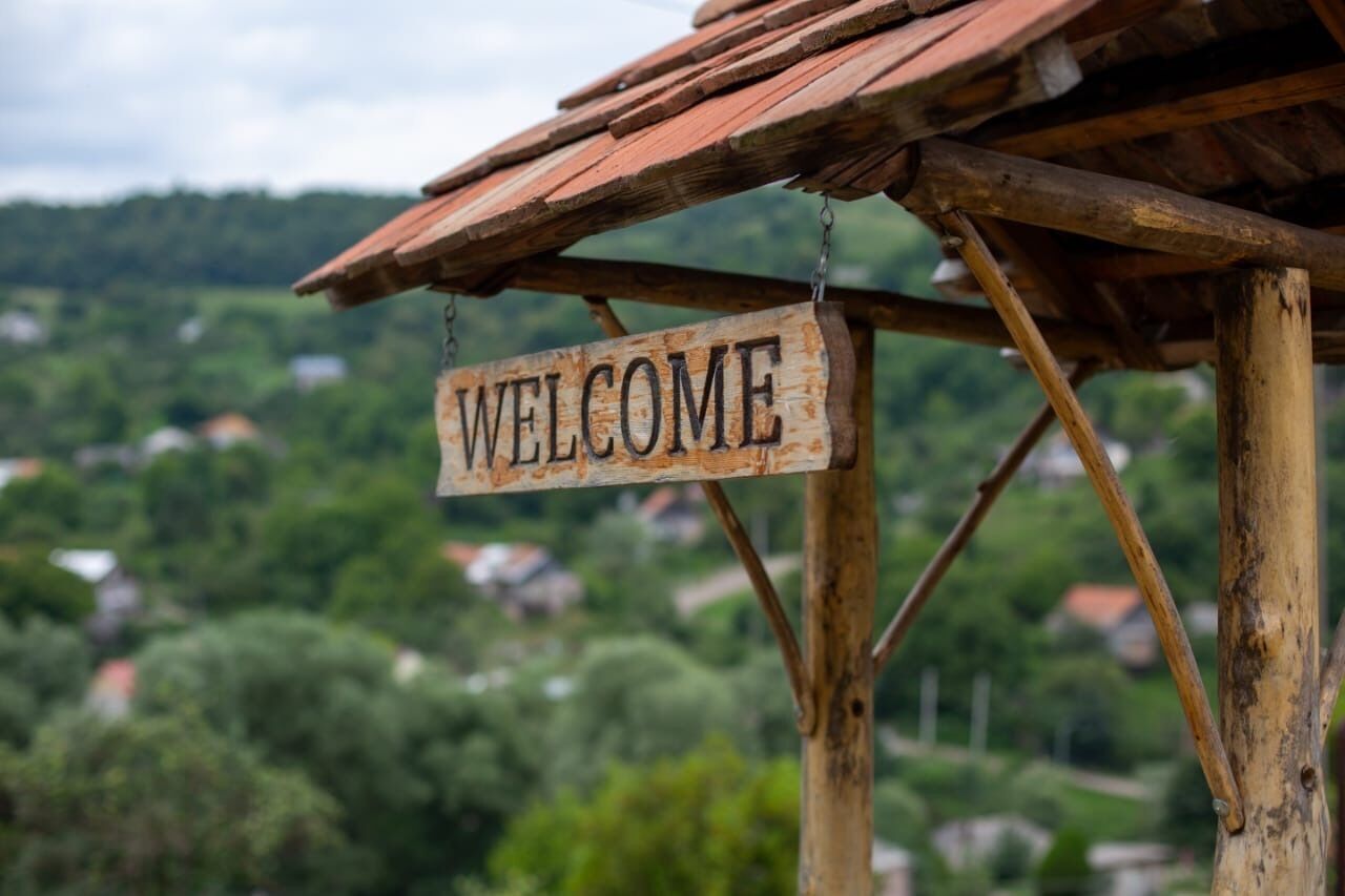 A wooden structure with a 'WELCOME' sign.