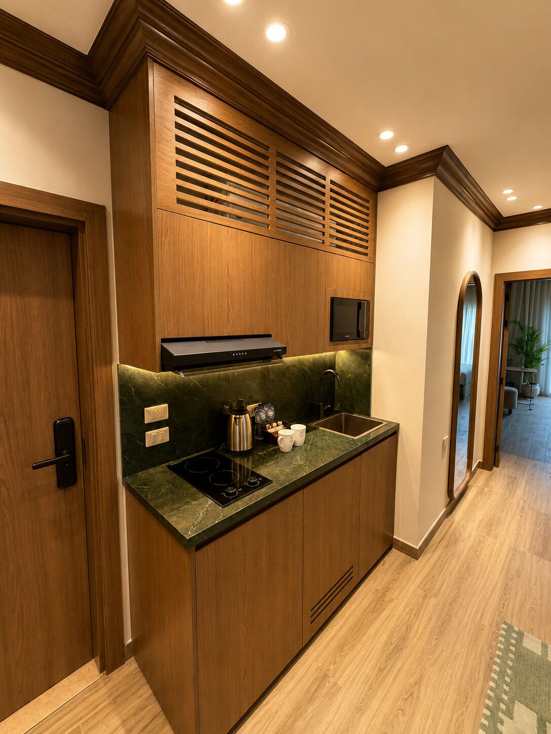 A modern kitchen with a built-in stove, microwave, and a coffee maker on the counter.
