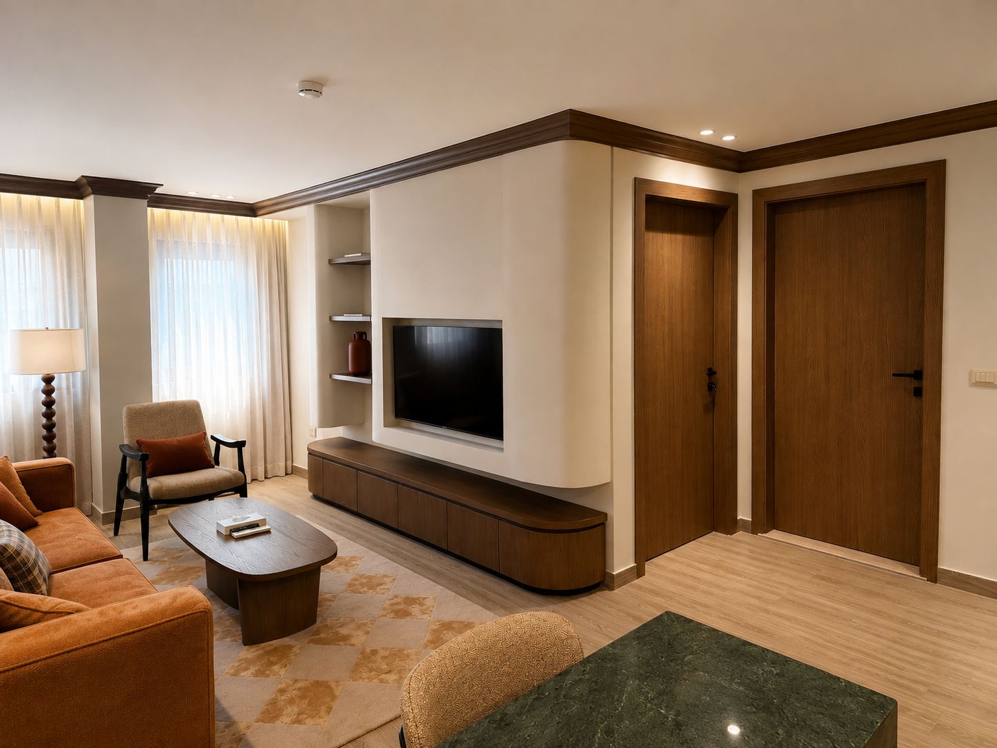 A modern living room with a flat-screen TV, a sofa, a coffee table, and a TV stand.