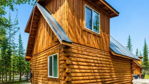 A log cabin with a gabled roof, a chimney, and a window. - Sterling Alaska Retreat | Nature at Your Doorstep (Sterling)