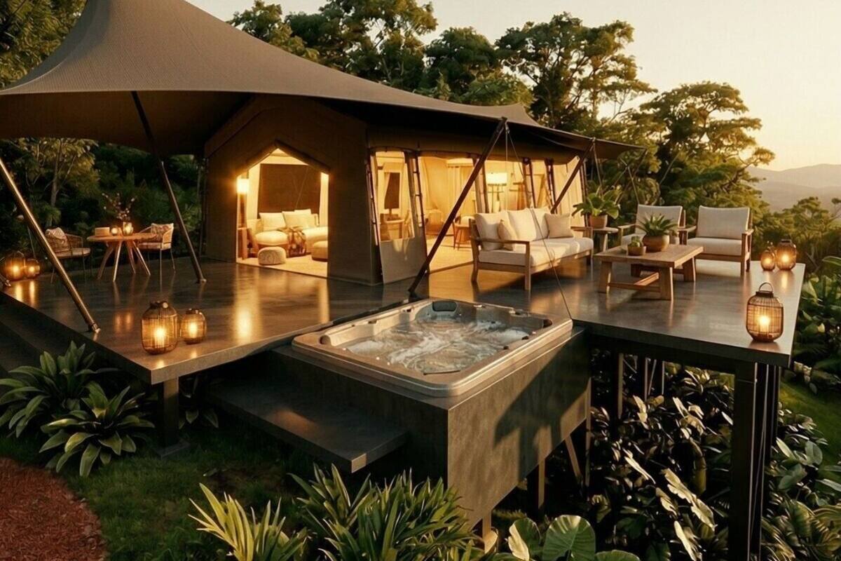 An outdoor lounge area with a hot tub, seating, and ambient lighting.
