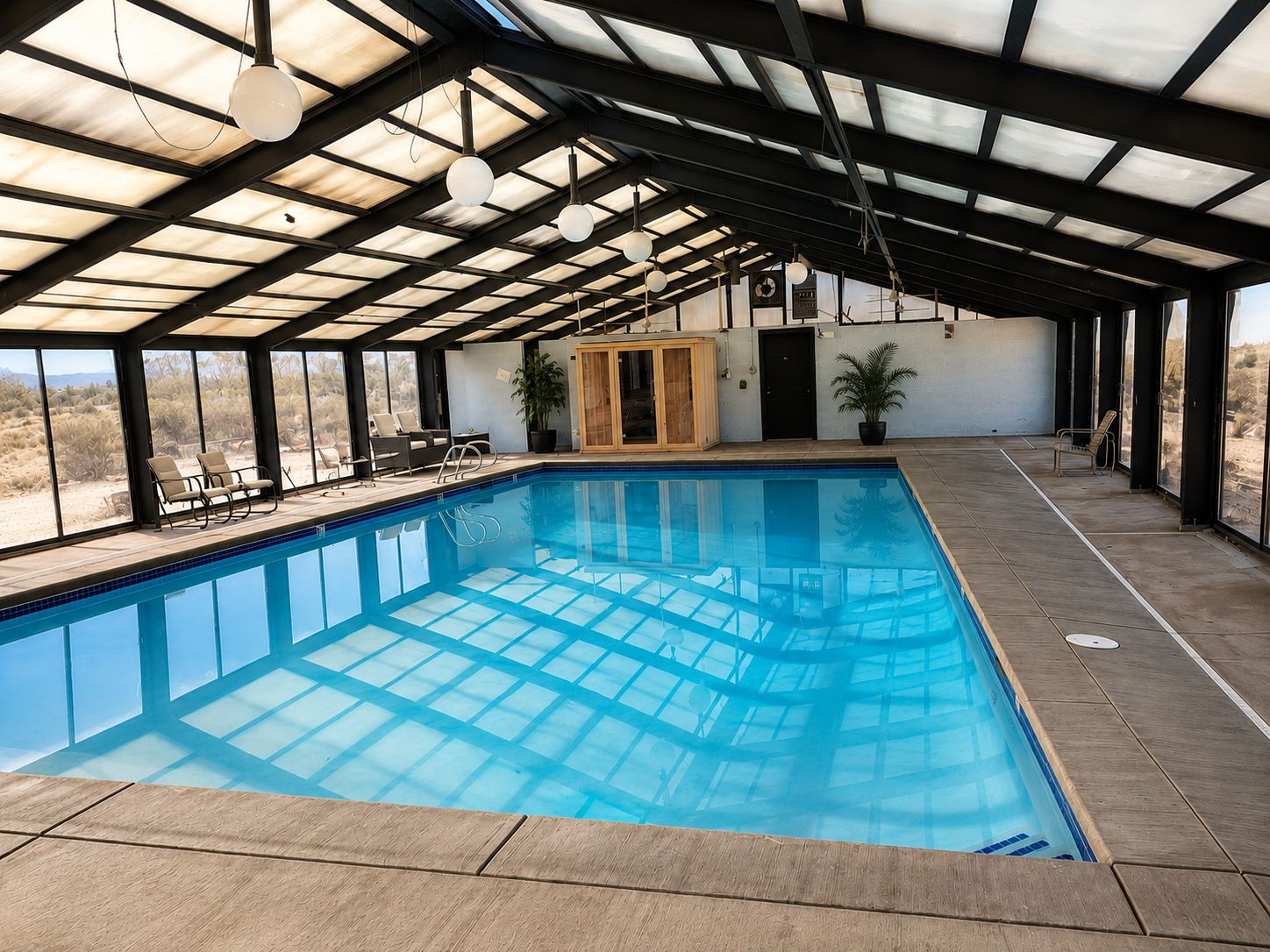 Una piscina interior con vistas despejadas al paisaje desértico a través de amplios ventanales.