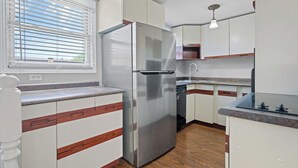 A modern kitchen with white cabinets, a stainless steel refrigerator, a wooden countertop, and a window with blinds. - Fun Pool for kids, parents, minutes to Niagara Falls, Clifton Hill, restaurants (Niagara Falls)