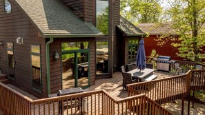 A wooden deck with outdoor furniture, a grill, and a covered patio area. - Private Whitefish Chain Family Retreat on Little Pine Lake - Sleeps 10 (Crosslake)