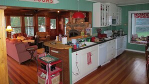A cozy cabin interior with a living area, kitchen, and a sign reading 'BOAT TOURS'.