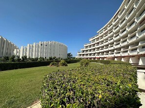 A modern building with a curved facade and multiple balconies. - Two-room apartment with terrace near beach, pets allowed (La Grande-Motte)