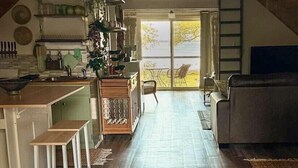 A loft-style room with a kitchen, dining area, and seating space.
