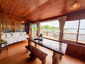 A wooden cabin with a bed, a table, and a bench.