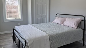 A bedroom with a bed, a window, and a door. - New build. 3 bedroom Townhouse walking distance to York Beaches. (York)