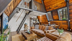 A loft-style living space with a wooden ceiling, a dining area, and a kitchen. - The Needles A-Frame Cabin! Grill/Hot tub/Pet friendly! (Flagstaff)