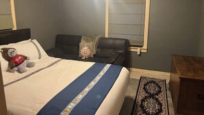 A bedroom with a bed, a ceiling fan, a window with blinds, a nightstand, and a rug. - 2-bedroom house in enchanting Bandera with cool AC breeze (Bandera)