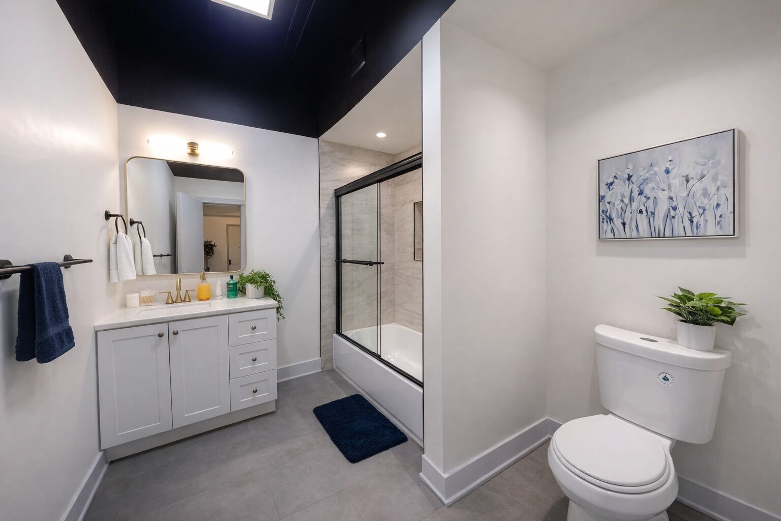 A modern bathroom with a shower, toilet, and sink.