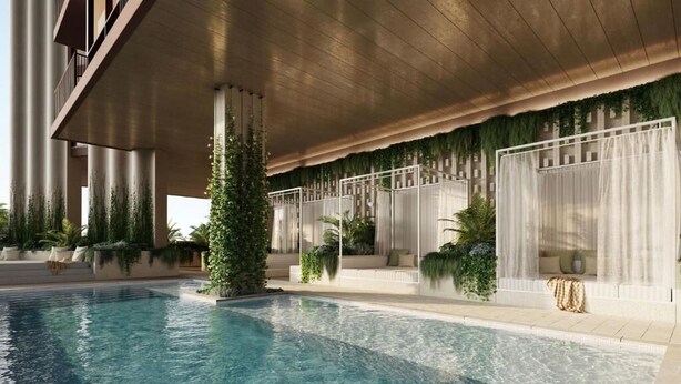 A swimming pool with a modern architectural design, including a covered area with seating and greenery. - Yves Residences - 2204 (Mermaid Beach)