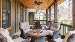 A covered outdoor seating area with wicker furniture, a ceiling fan, and a fire pit. - The Sugar Chalet - Luxury home on Sugar, easy access, views! (Sugar Mountain)