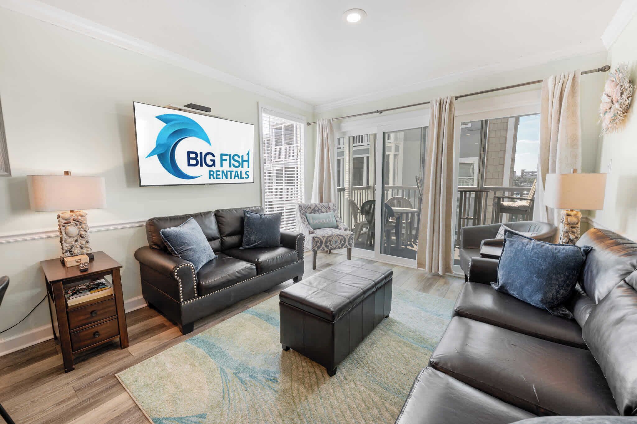 A modern living room with a leather sofa, a coffee table, and a TV mounted on the wall.