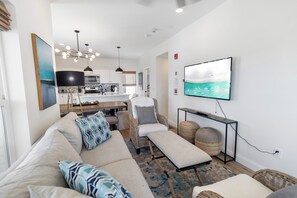 Relax in your spacious living room with coastal-inspired décor and modern comfort. The open-plan kitchen flows seamlessly into your lounge, perfect for easy entertaining and unwinding after a day exploring the area. - ☀️Villas Laguna #2 - Exceptional Views, Pool, Walk to Beach (Panama City Beach)