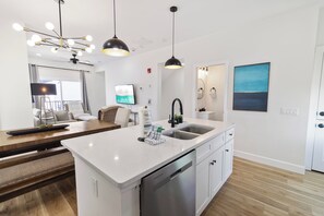 A modern kitchen with a central island, stainless steel appliances, and pendant lighting. - 🌊 Villas Laguna Beach #4 –  Gulf Views, Pool, Pets OK, Beach Access (Panama City Beach)