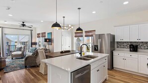A modern kitchen with white cabinetry, stainless steel appliances, and pendant lighting. - 🌊 Villas Laguna Beach #4 –  Gulf Views, Pool, Pets OK, Beach Access (Panama City Beach)