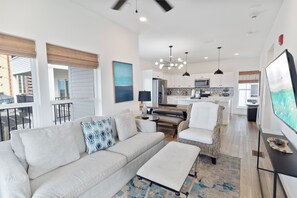A modern living room with a sofa, a coffee table, and a television. - 🌊 Villas Laguna Beach #9 - Gulf Views, Rooftop Terrace, Private Pool, Pets! (Panama City Beach)