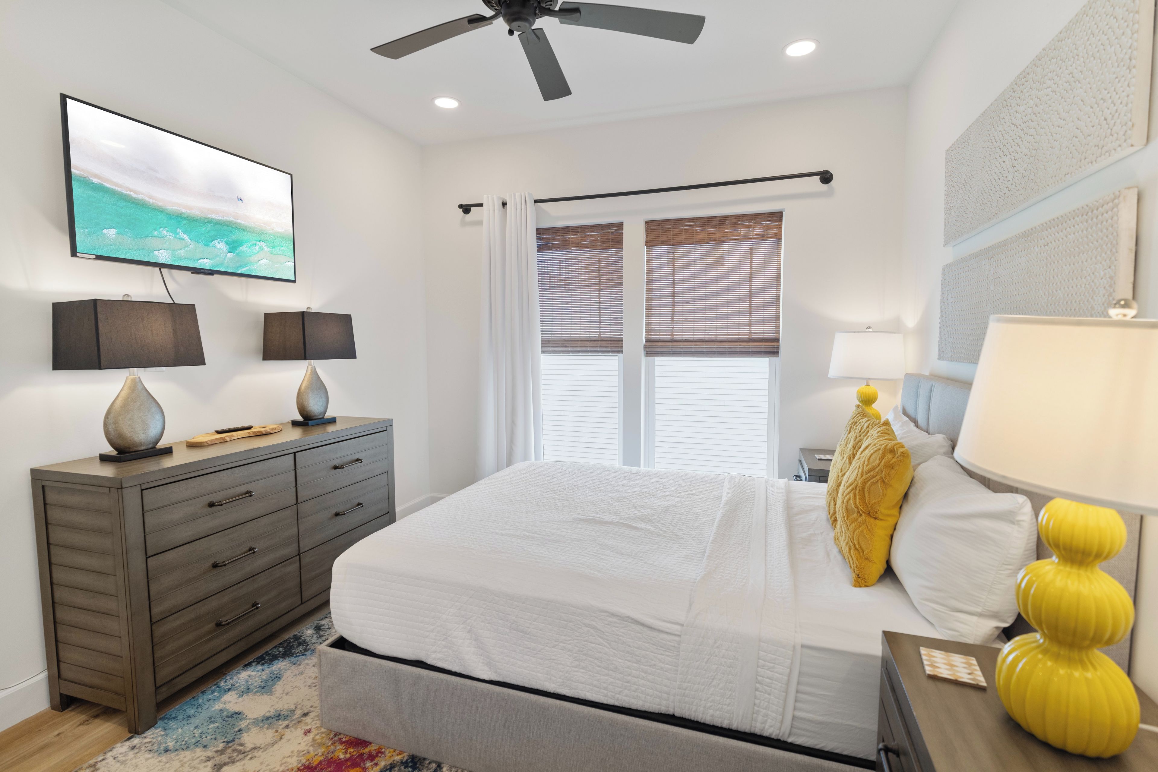 Unwind in your bright, coastal-inspired bedroom where crisp linens and cheerful pops of color invite restful nights. Natural light filters through the windows, while the ceiling fan keeps you comfortable year-round.