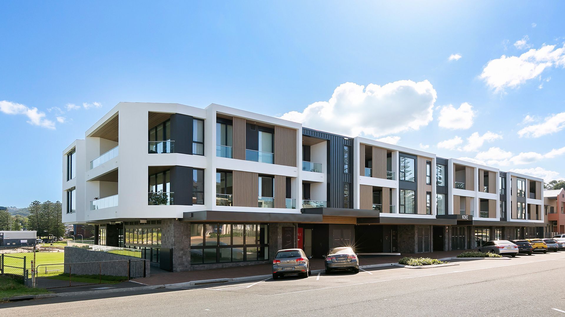 A multi-story hotel with a modern architectural design, featuring large windows and balconies.